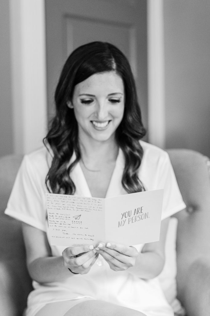 Bride reads a handwritten note from her groom