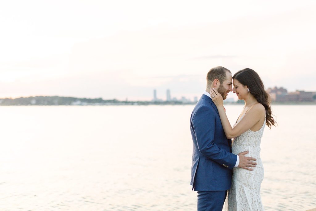 Massachusetts elopement with a couple holding each other in front of the marina
