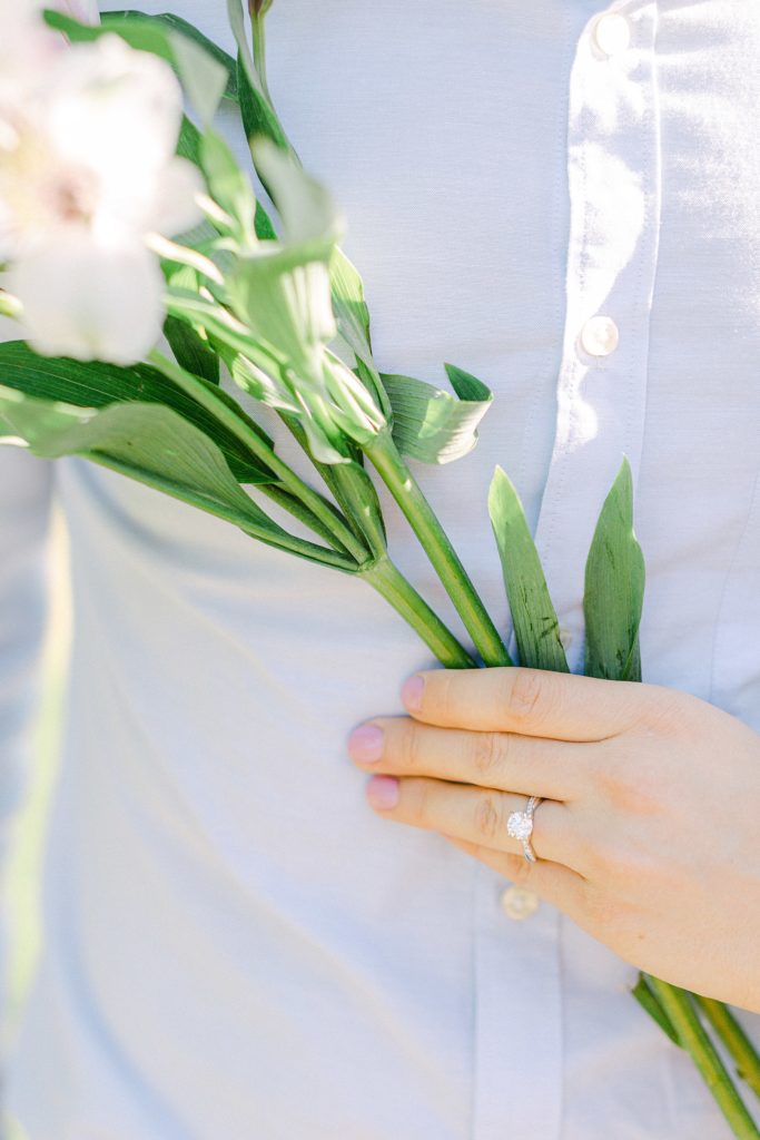 Wedding ring photo with a strand of flowers
