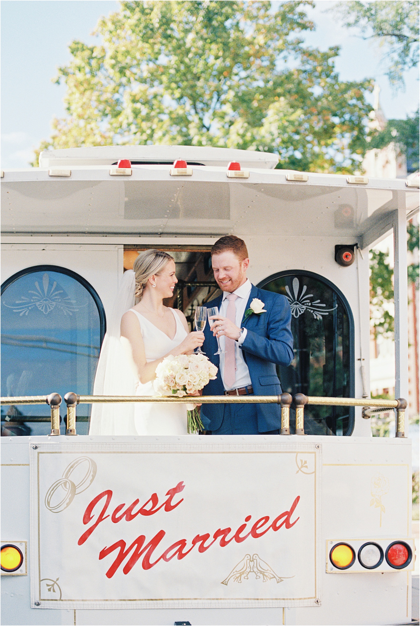 bride and groom on trolley in boston four seasons wedding