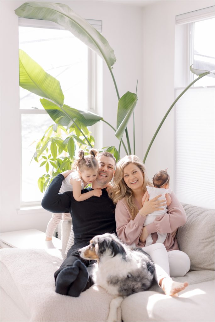 Boston family of four with their dog at home 